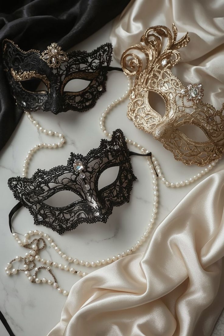 Lace masquerade masks and pearls on satin